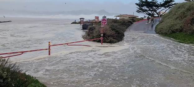 A road with a red rope and a red sign on it

Description automatically generated with medium confidence